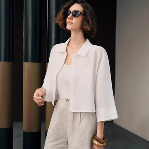Minimalist white cotton long sleeve shirt for women with lapel and pocket design