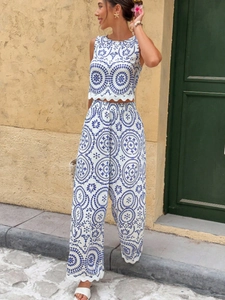 Detail of blue and white floral printed two-piece set featuring scalloped edges and linen texture