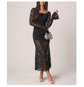 Detailed view of black lace long sleeve dress featuring flare sleeves and 3D floral collar