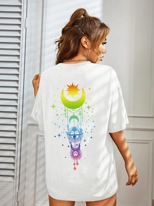 Detail of artistic rainbow sun and moon print on back of white loose cotton T-shirt