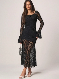 Detail of square neckline with rose decoration on black floral lace long sleeve dress