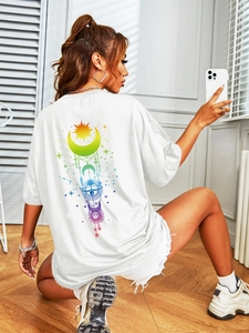 Detail of colorful mystic sun and moon graphic print on white oversized cotton t-shirt