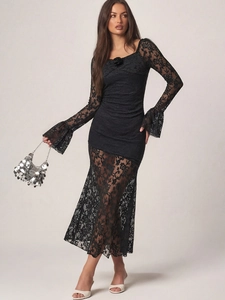 Close-up of black lace dress featuring vintage flared cuffs and 3D floral square neckline