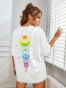 Close-up of bohemian rainbow celestial print with sun and moon on white cotton t-shirt