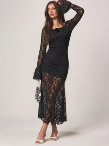 Detailed texture of black lace dress featuring long flared sleeves and floral neckline