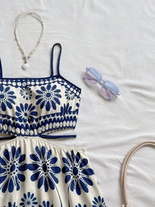 Chic cream floral sundress with cutout waist and blue flowers for summer vacations