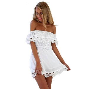 Detail of white off-shoulder mini dress with lace crochet trim and ruffled neckline