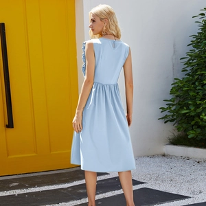 Detail view of light blue sleeveless summer dress with ruffled back and keyhole button closure
