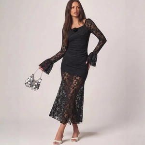 Elegant black lace long sleeve dress with floral neckline and sheer flared hemline