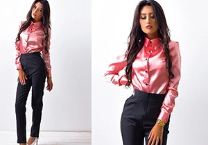 Detail of pink satin long sleeve shirt with classic lapel and dark button closure