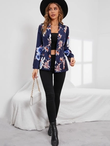 Detailed side view of a slim-fit navy blazer with bright orange floral print pattern