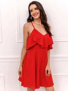 Detail of red backless summer dress featuring a deep V-neck and tiered ruffle layers