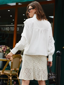 Elegant white long sleeve blouse with ruffled trim and matching floral lace midi skirt