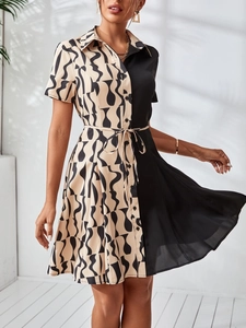 Detail of shirt dress with waist tie, contrast color blocking and abstract print
