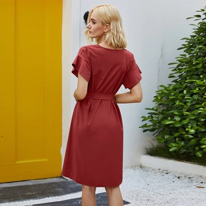 Detail of burgundy V-neck dress featuring ruffled sleeves and adjustable waist tie belt