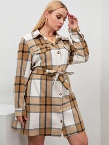 Detail of long-sleeve plaid shirt dress with classic check pattern and waist belt