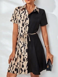 Detailed close-up of short sleeve collared dress with waist tie and color block print