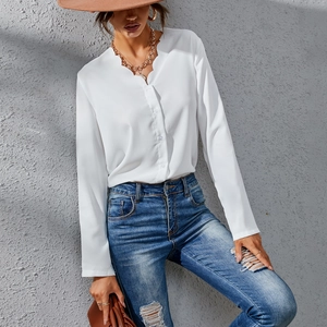 Detailed scalloped V-neckline and button-down front on a white long sleeve chiffon blouse