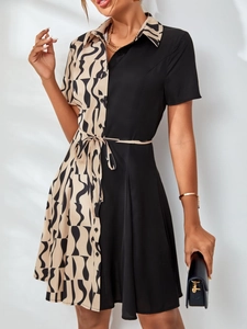 Detail of waist-cinching belt and patchwork print on a stylish shirt dress for women