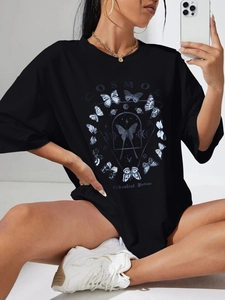 Detail showing oversized black T-shirt with butterfly cosmos graphic and dropped shoulders