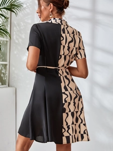 Detail of printed patchwork shirt dress with waist tie and abstract wave pattern