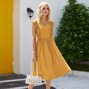 Detail of yellow sleeveless summer dress with ruffle shoulders and a woven bag