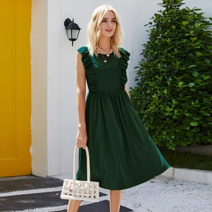 Detail of dark green sleeveless dress with ruffled shoulders and white woven handbag