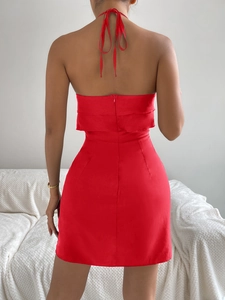 Detail of red backless satin halter dress with hidden zipper and smooth silky texture