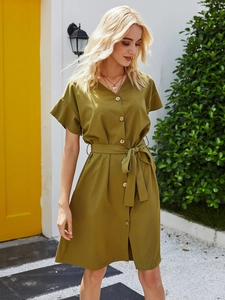 Detail of olive green V-neck dress with wooden buttons and waist belt in French style