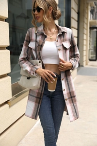 Detail of pink and brown plaid shacket featuring chest pockets and oversized silhouette