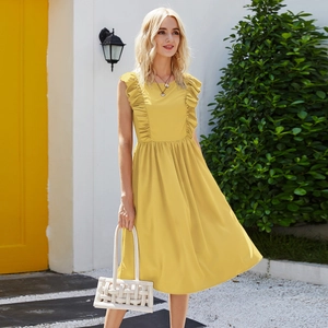 Detail of yellow sleeveless summer dress featuring ruffled shoulders and a cinched waistline