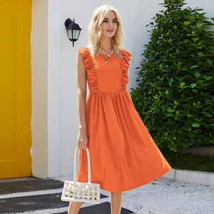 Detail of bright orange sleeveless dress featuring tiered ruffles and A-line silhouette