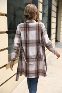 Rear view of long-sleeved plaid dress in pink and brown with a matching waist tie belt