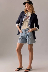 Detail shot of khaki t-shirt with 1989 letter print paired with denim shorts