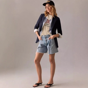 Women's casual cream t-shirt with 1989 lettering paired with a navy blazer and denim shorts