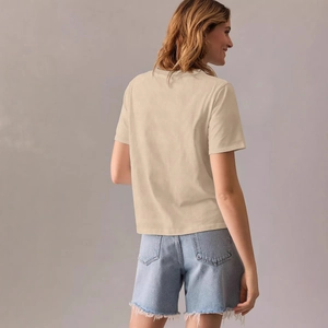 Minimalist beige crew neck T-shirt with back view on model and denim shorts