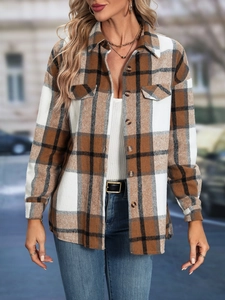 Detail of brown plaid shirt jacket featuring chest flap pockets and button-down front