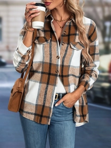 Detail of plaid long sleeve jacket with front button closure and double chest pockets