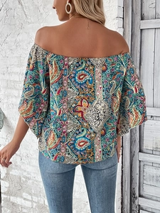 Detail of the boho off-shoulder top featuring vibrant paisley patterns and floral prints