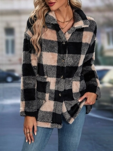Close-up of black and pink checkered flannel jacket featuring plush texture and buttons