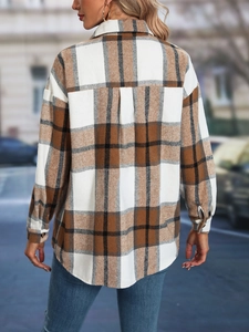 Detail view of the back of a brown plaid shacket featuring drop shoulders and curved hem