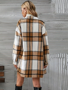 Detail view of the back of a brown and black plaid shacket in a loose silhouette style