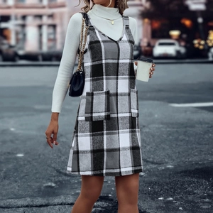 Detail von kariertem Trägerkleid mit V-Ausschnitt und doppelten Taschen auf der Straße
