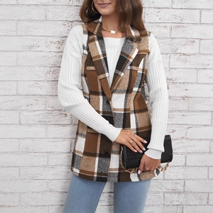 Women's plaid long vest with notched lapels and buttons over a white turtleneck