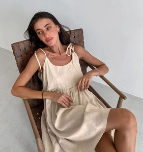 Close-up of a cream summer slip dress showing high waist elastic and linen texture