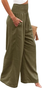 Detail of high waisted smocked waist and side pockets on olive green wide leg pants