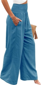 Detail of high waisted smocked waist and side pockets on linen wide leg trousers
