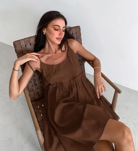 Detail view of dark brown linen-blend dress featuring fine straps and gathered waist texture