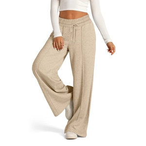 Detail of light beige wide-leg trousers with drawstring waist and vertical seam lines