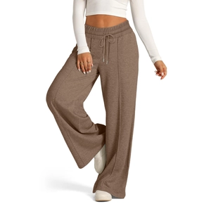 Detail of high-waist brown wide-leg trousers with drawstring and stitched front seam lines